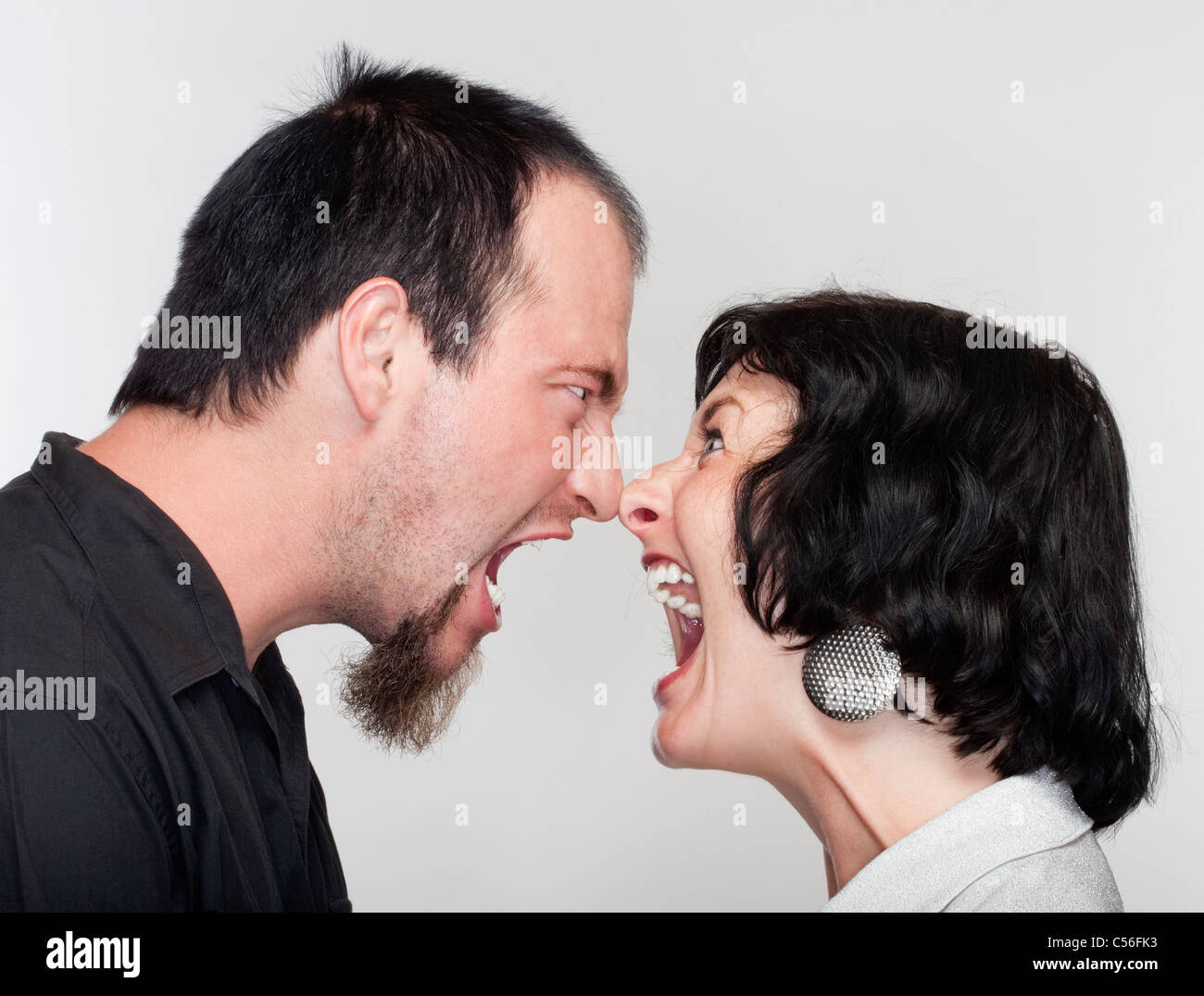 couple fighting, yelling at each other - isolated on white Stock Photo