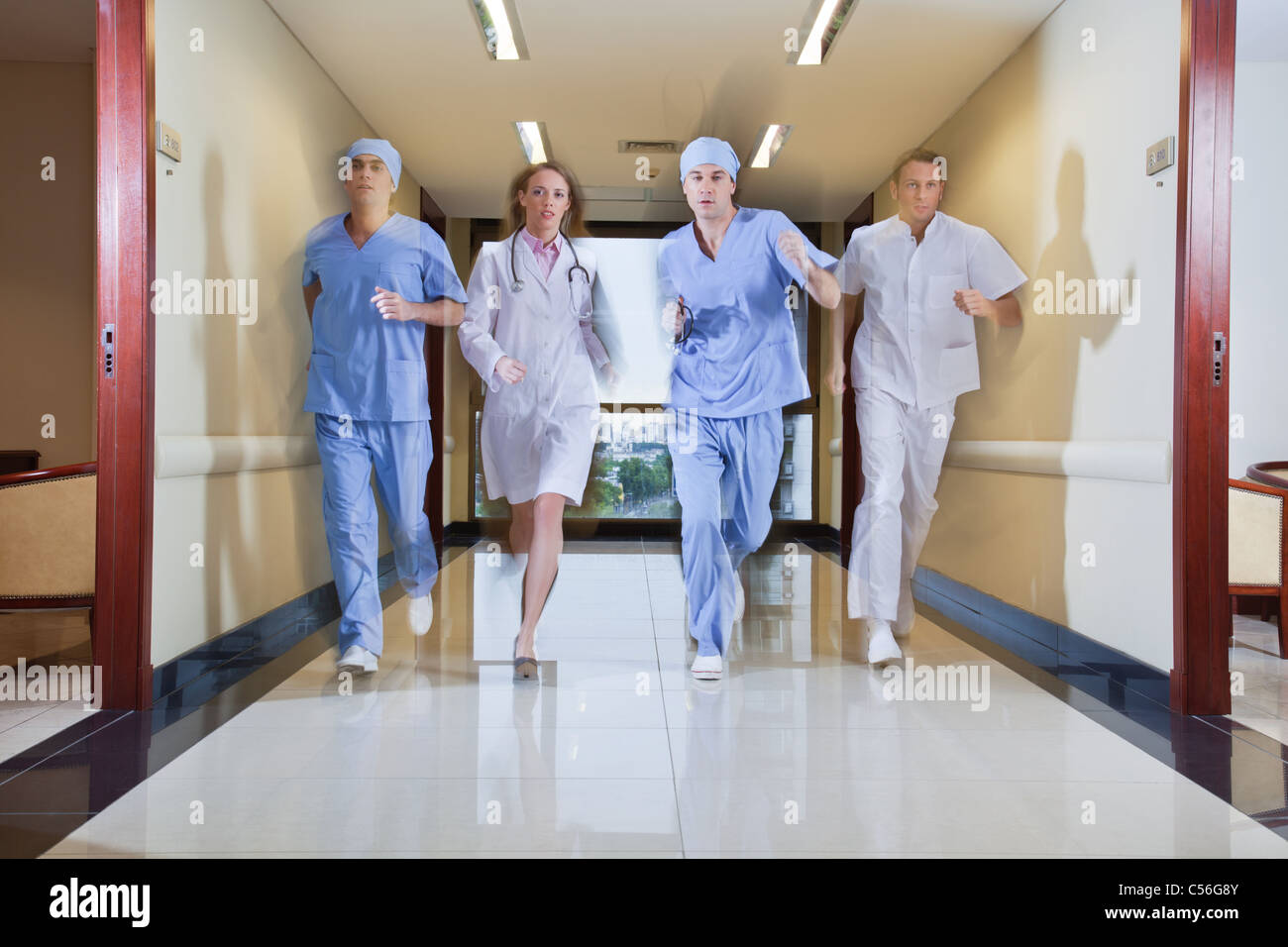 Team of surgeon and nurse running in hallway of hospital Stock Photo