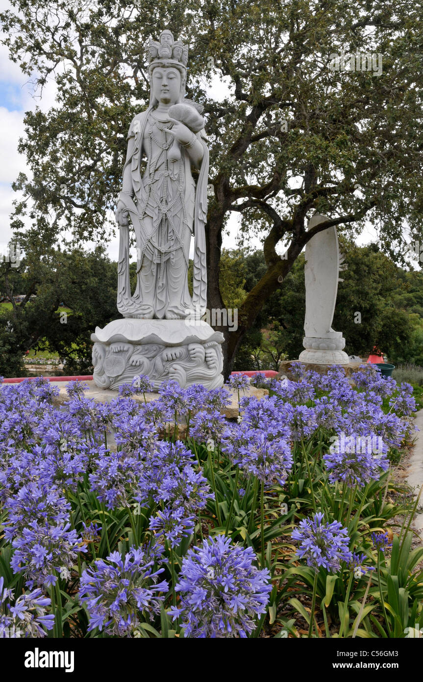 Big white stone statues of gods. Buddha Eden Garden or Garden of Peace