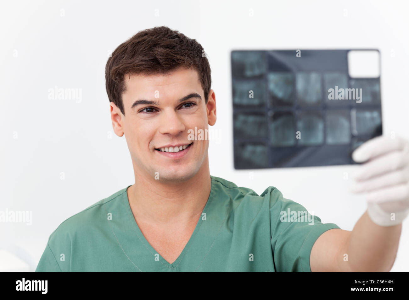 Young smiling doctor analyzing a dental XRay detail Stock Photo Alamy