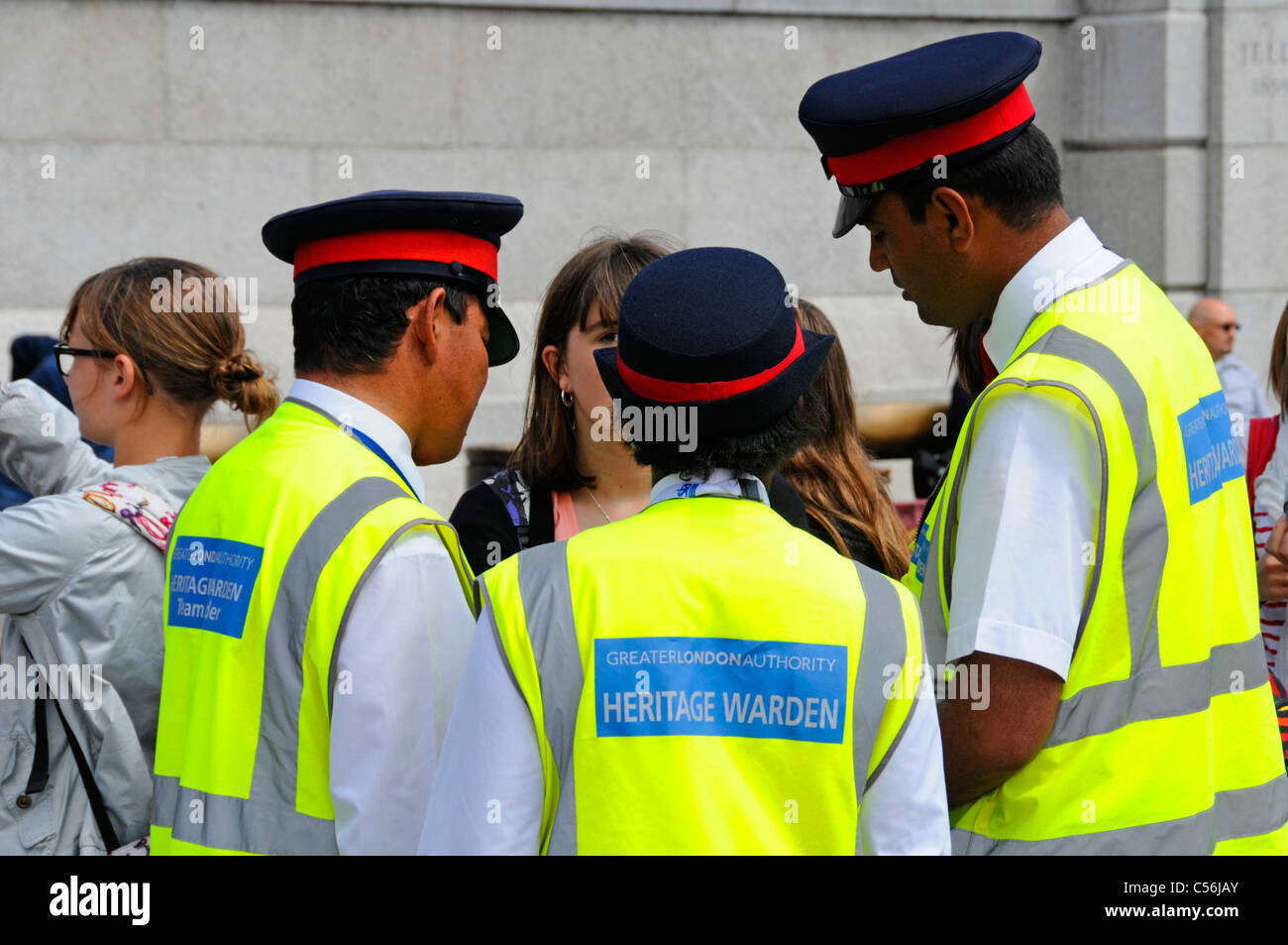 Three Heritage Wardens assisting visitors in London Stock Photo