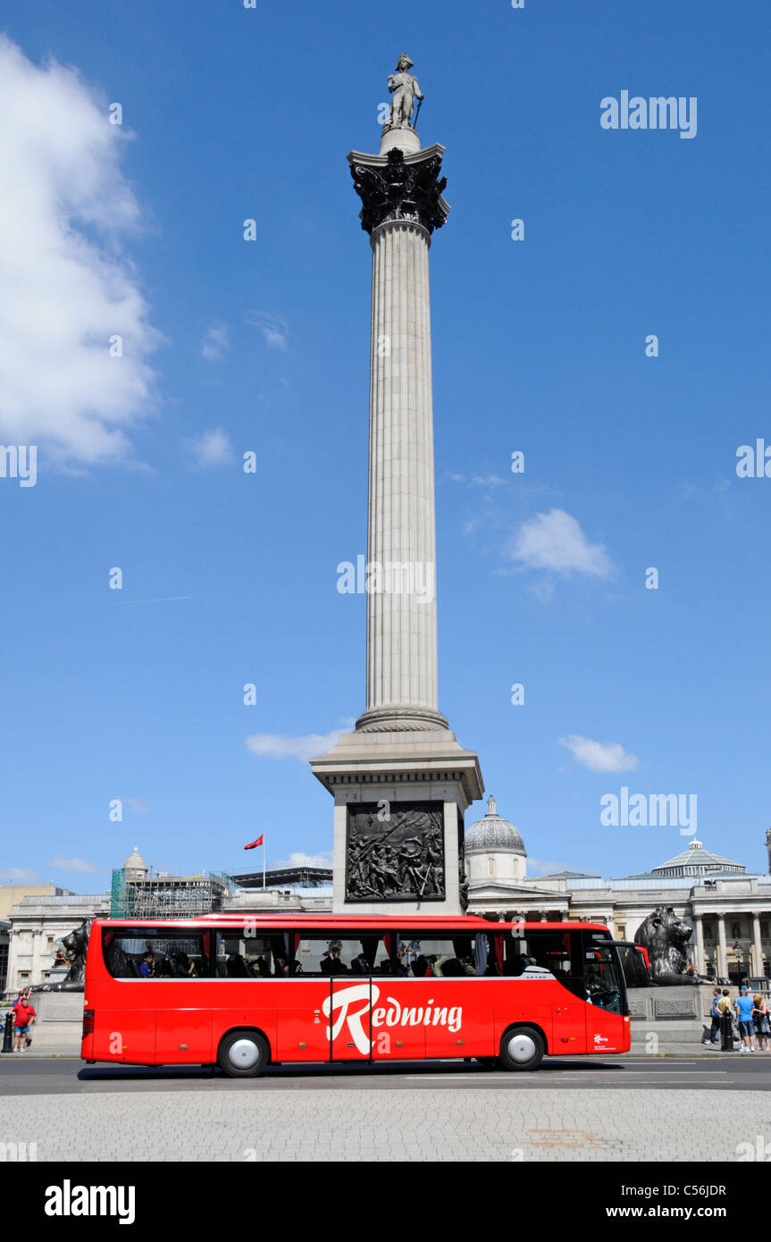 Redwing tour coach passing Nelsons Column Trafalgar Square London England UK Stock Photo