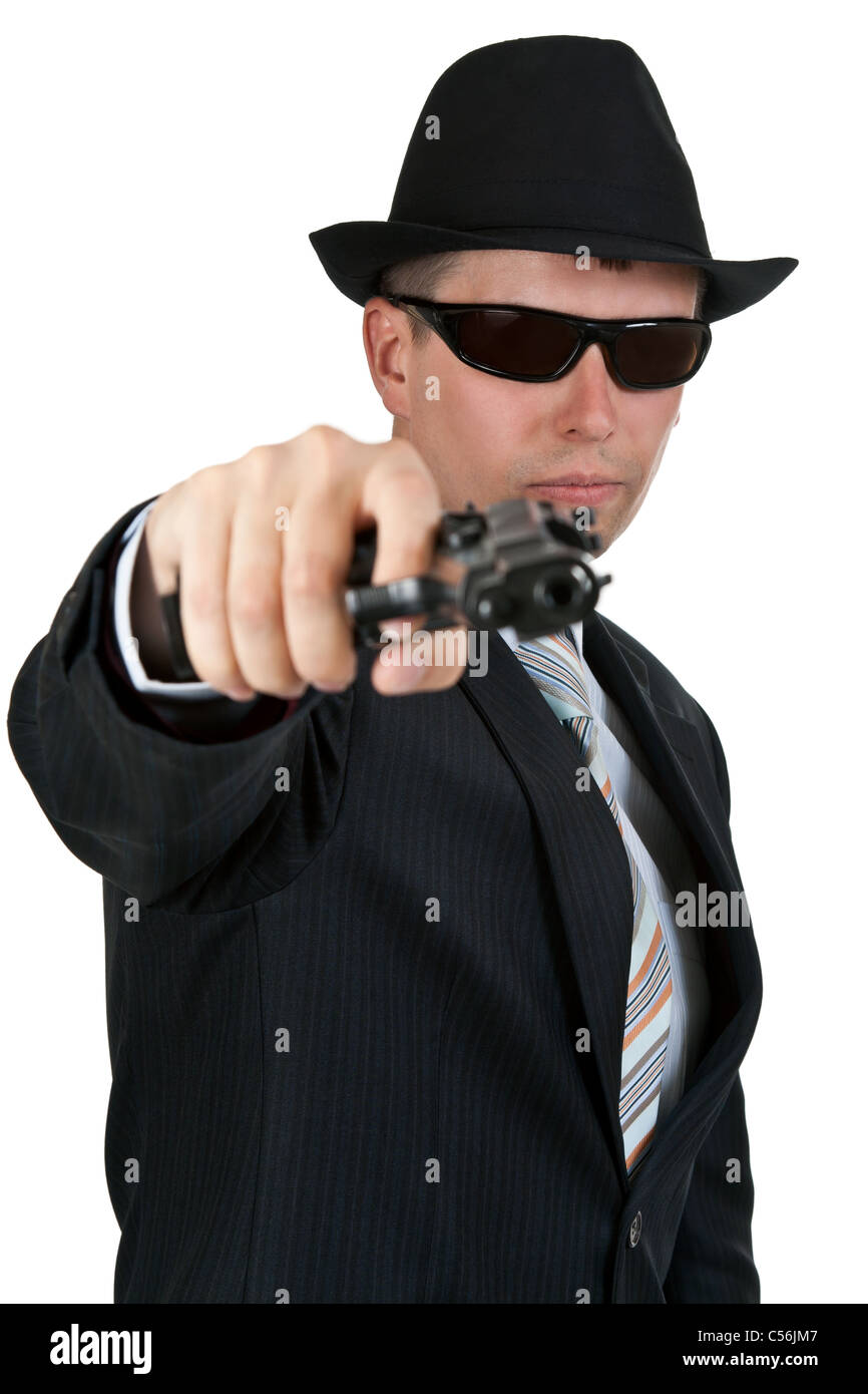 businessman in a hat and sunglasses with a gun on a white background Stock Photo