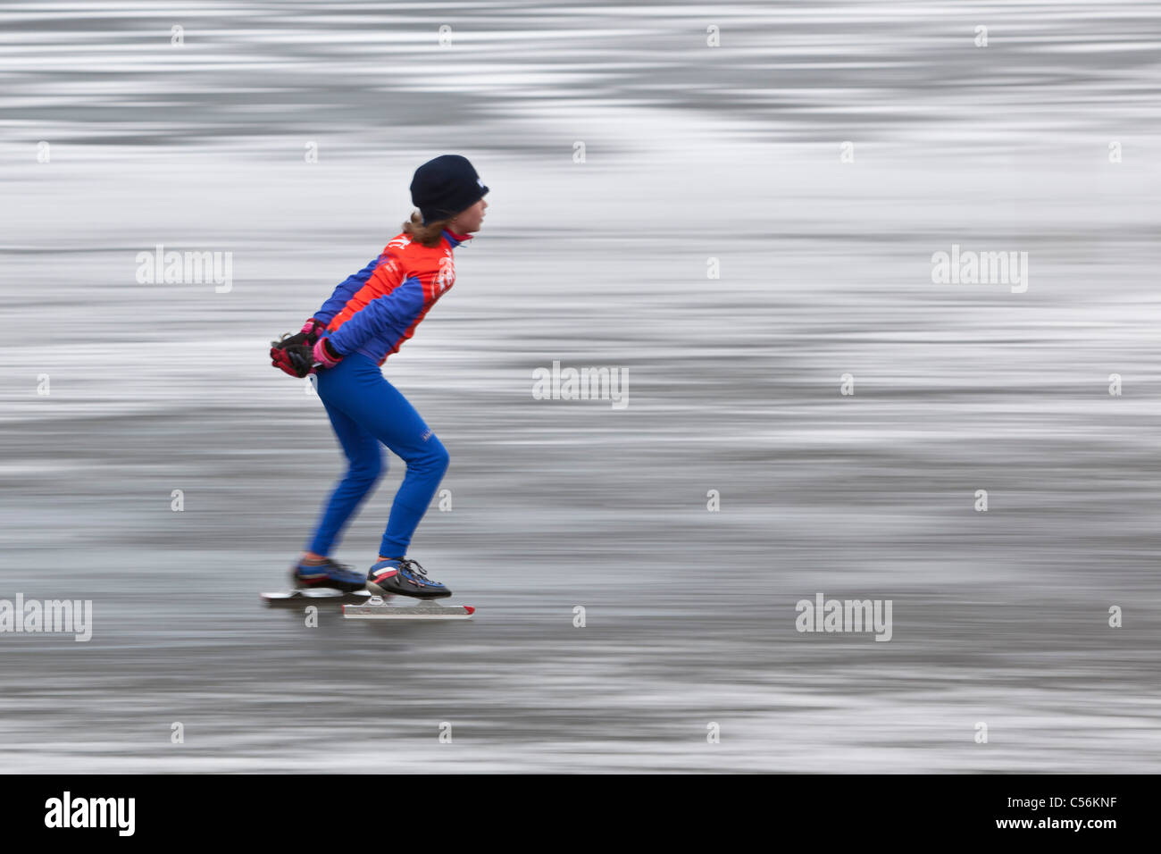 The Netherlands, Ankeveen. Girl ice skating. Motion blurred. Stock Photo