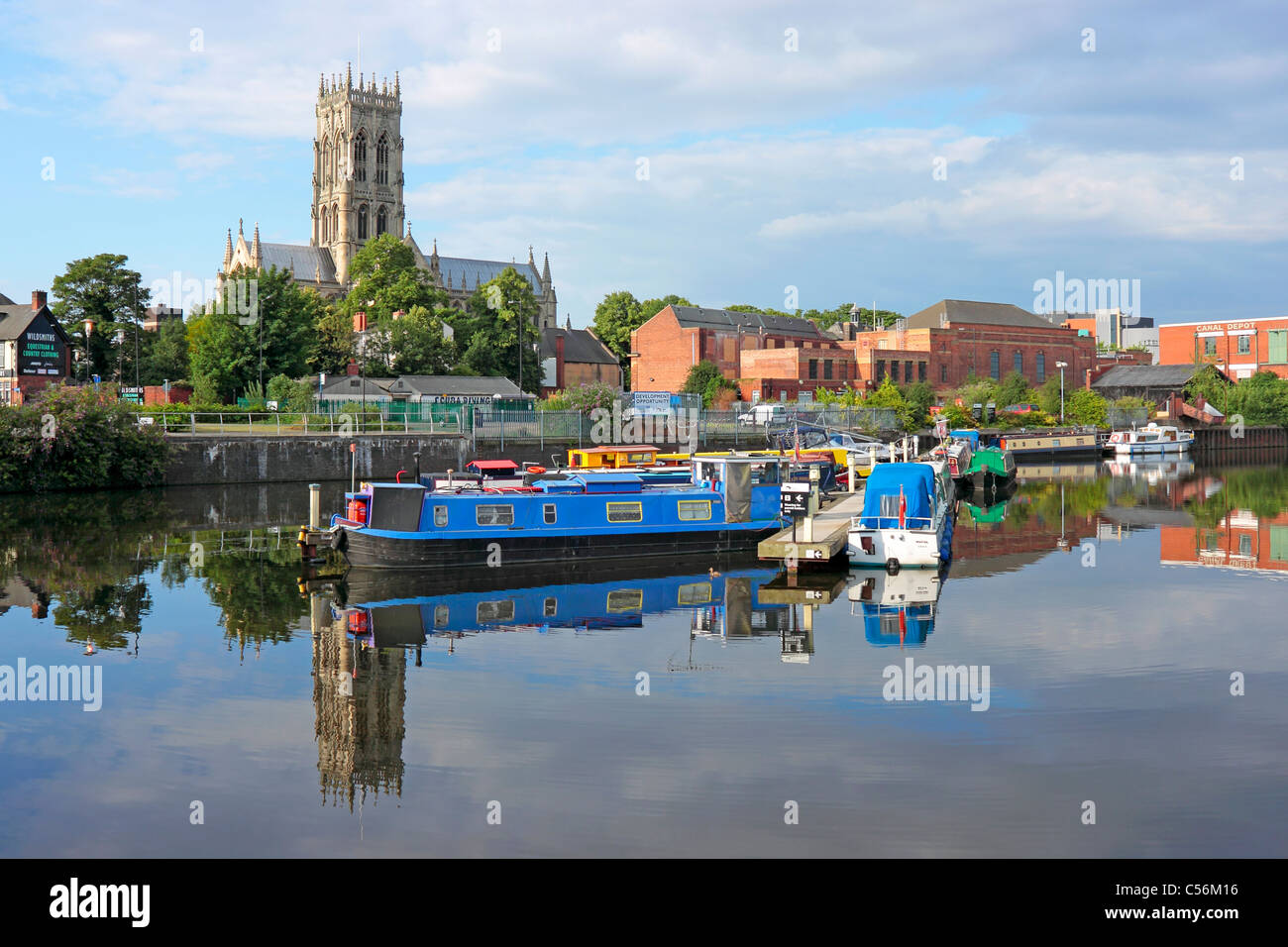 Doncaster Minster St Georges Church northern aspect across the canal from the Waterfront with moored up house boats on the canal in front Stock Photo