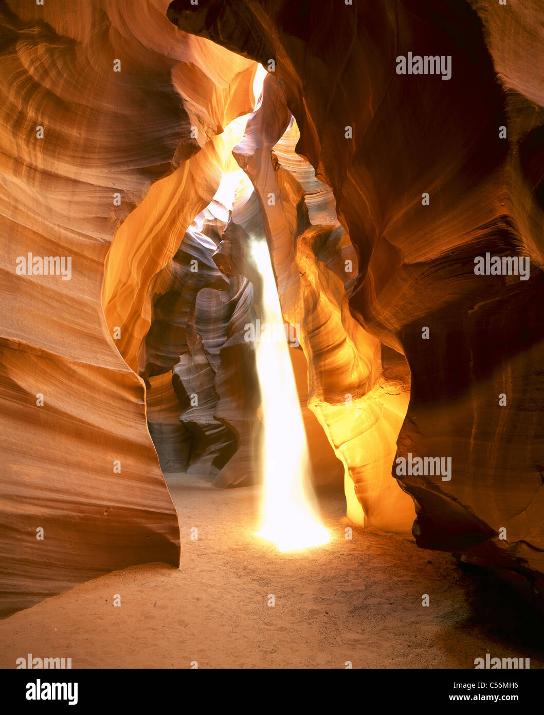 In the summer, rays of sunlight create ghostly appearances in this dusty slot canyon. Upper Antelope Canyon, Coconino County, Arizona, USA. Stock Photo