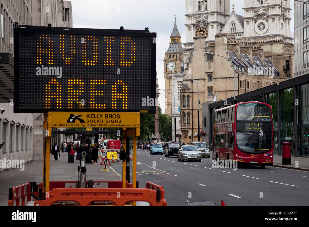 A roadworks sign in Westminster warms motorists to Avoid Area. Ironically with the backdrop of the Houses of Parliament, London. Stock Photo