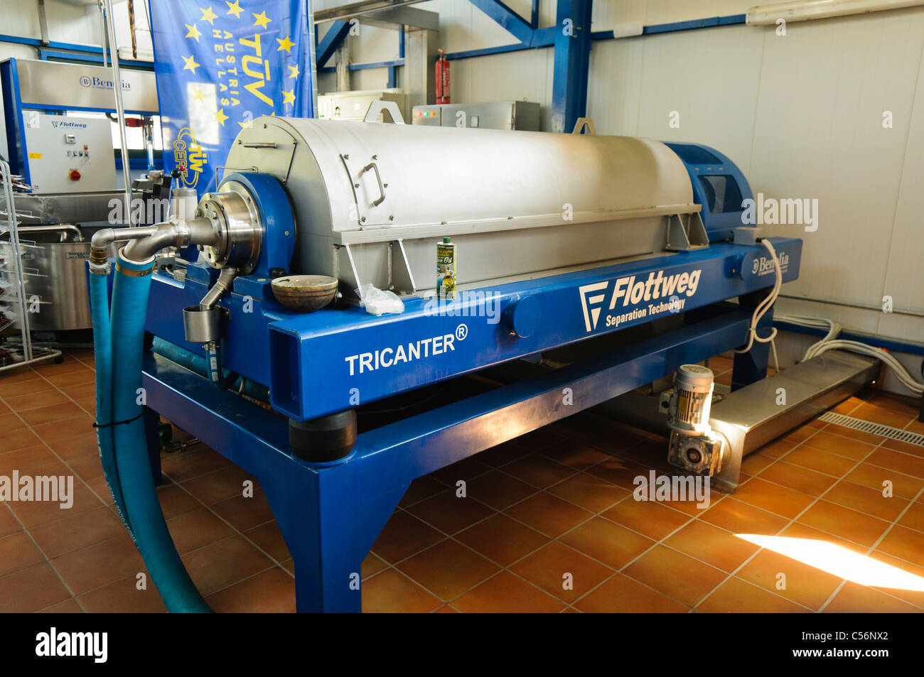 Industrial centrifuge at an Olive Oil production factory which separates the oil from ground olive paste. Stock Photo