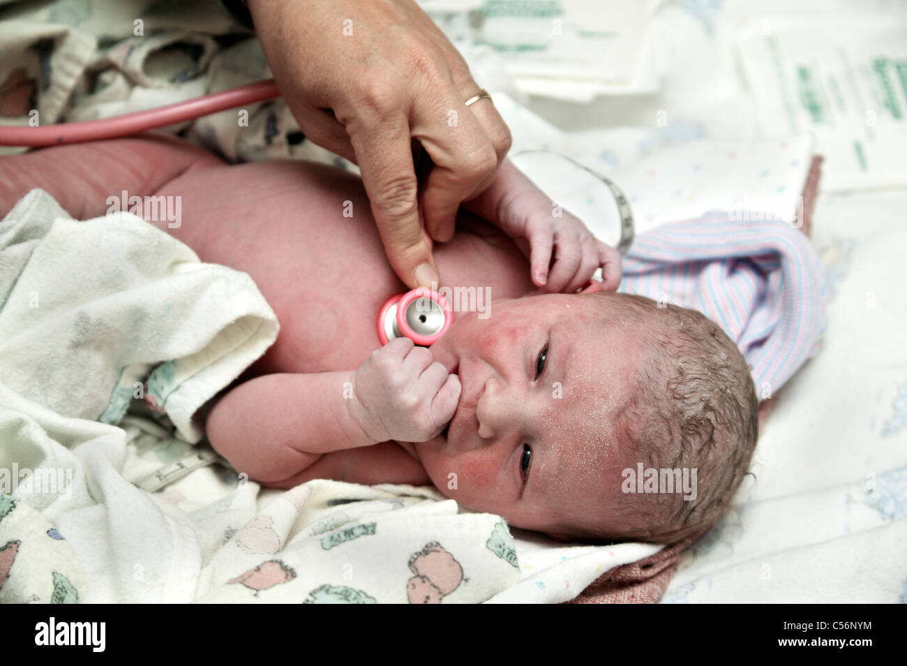 Newborn, midwife using stethoscope Stock Photo
