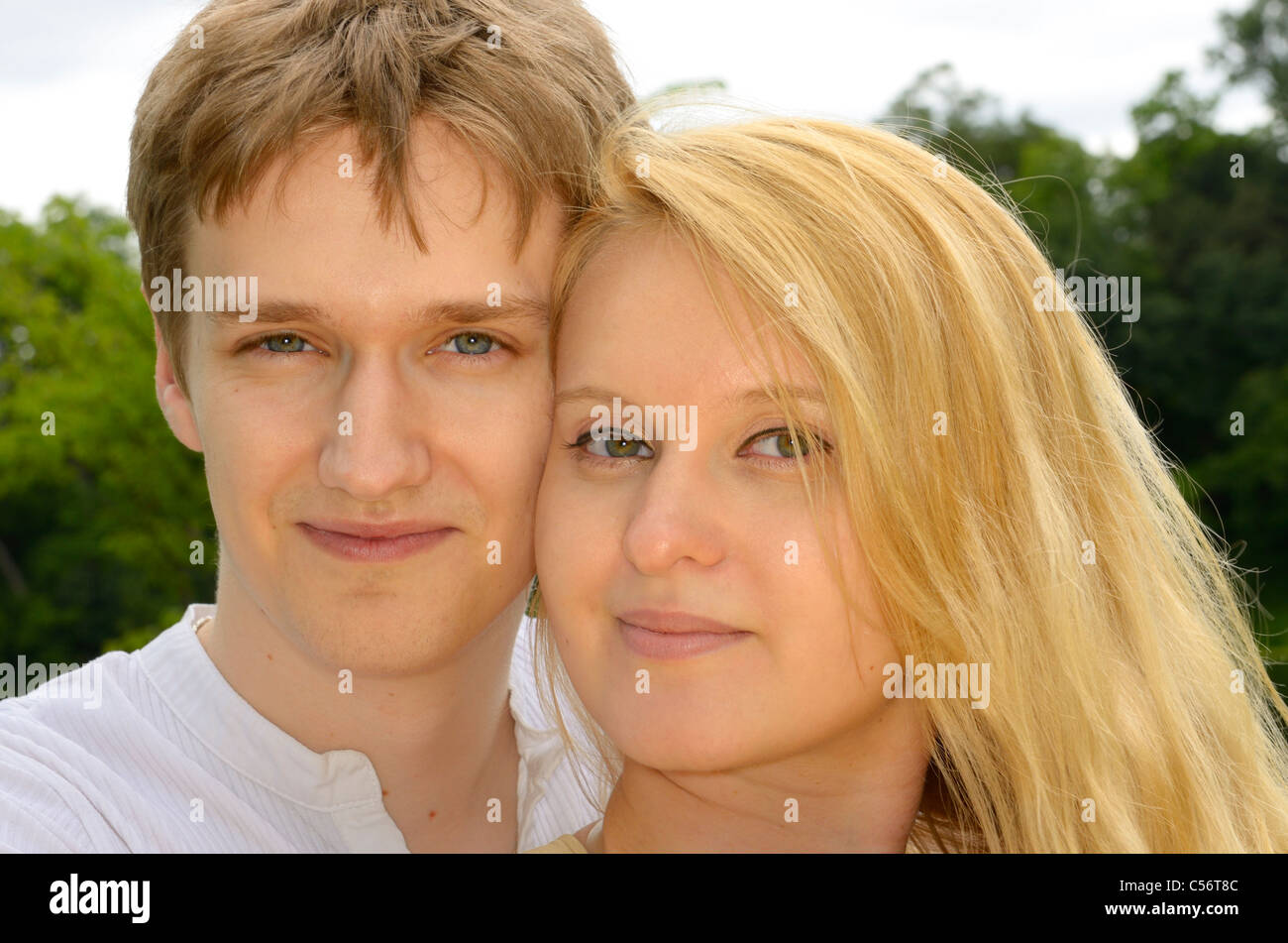 Faces of cheek to cheek loving couple of white Eastern European descent Stock Photo