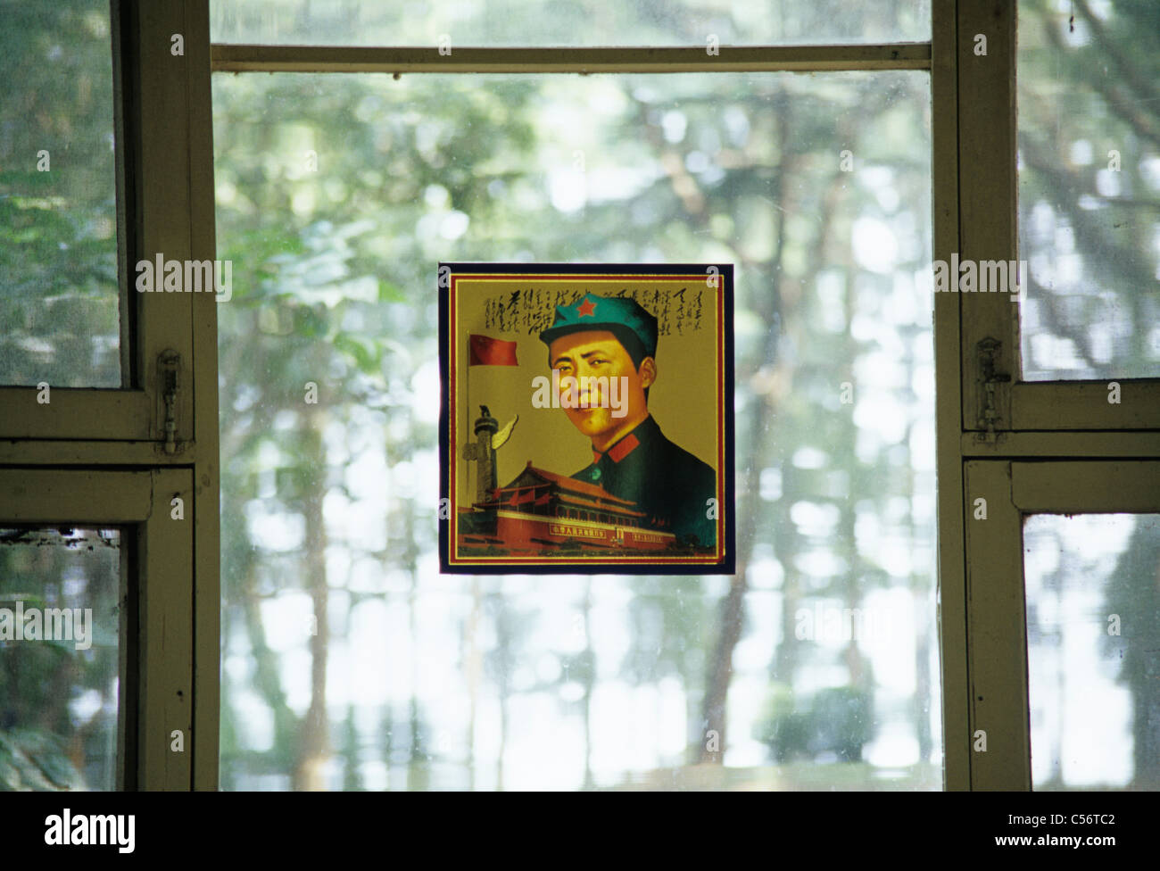 Chongqing, China . Portrait of young Mao Zse Tung hangs on window of former summer headquarters of Mao. 2006. © Bob Kreisel Stock Photo
