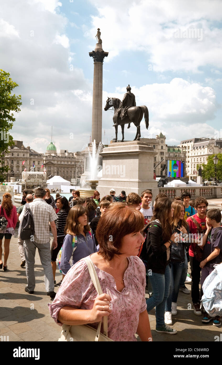 London tourists; Crowds of tourists in Trafalgar Square London UK Stock Photo