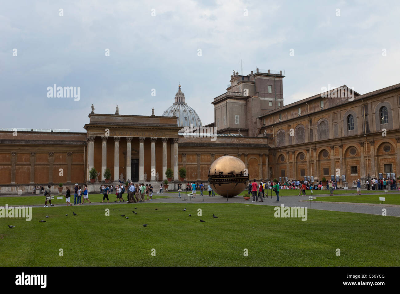 Vatican Saint Peter's coutyard with bronze Sphere Within Sphere and with large crowd of visitors. Rekindle, Despain Stock Photo