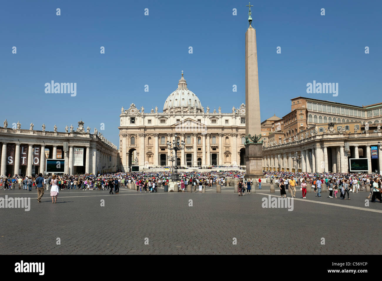 Vatican City Saint Peter's Square from down the road with traffic and tour bus. Famous courtyard and plaza. Stock Photo