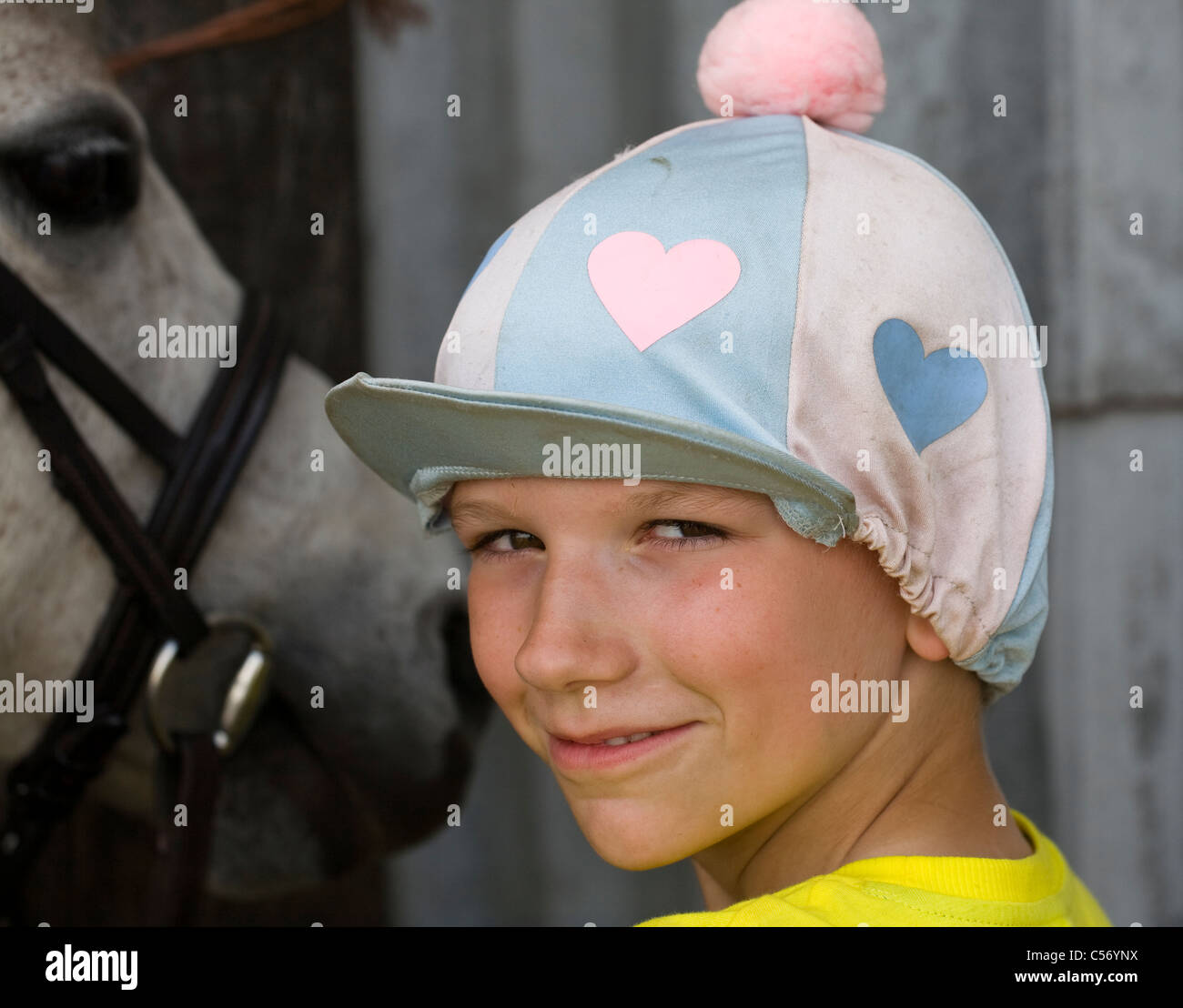 Young horse rider wearing riding hat Stock Photo Alamy