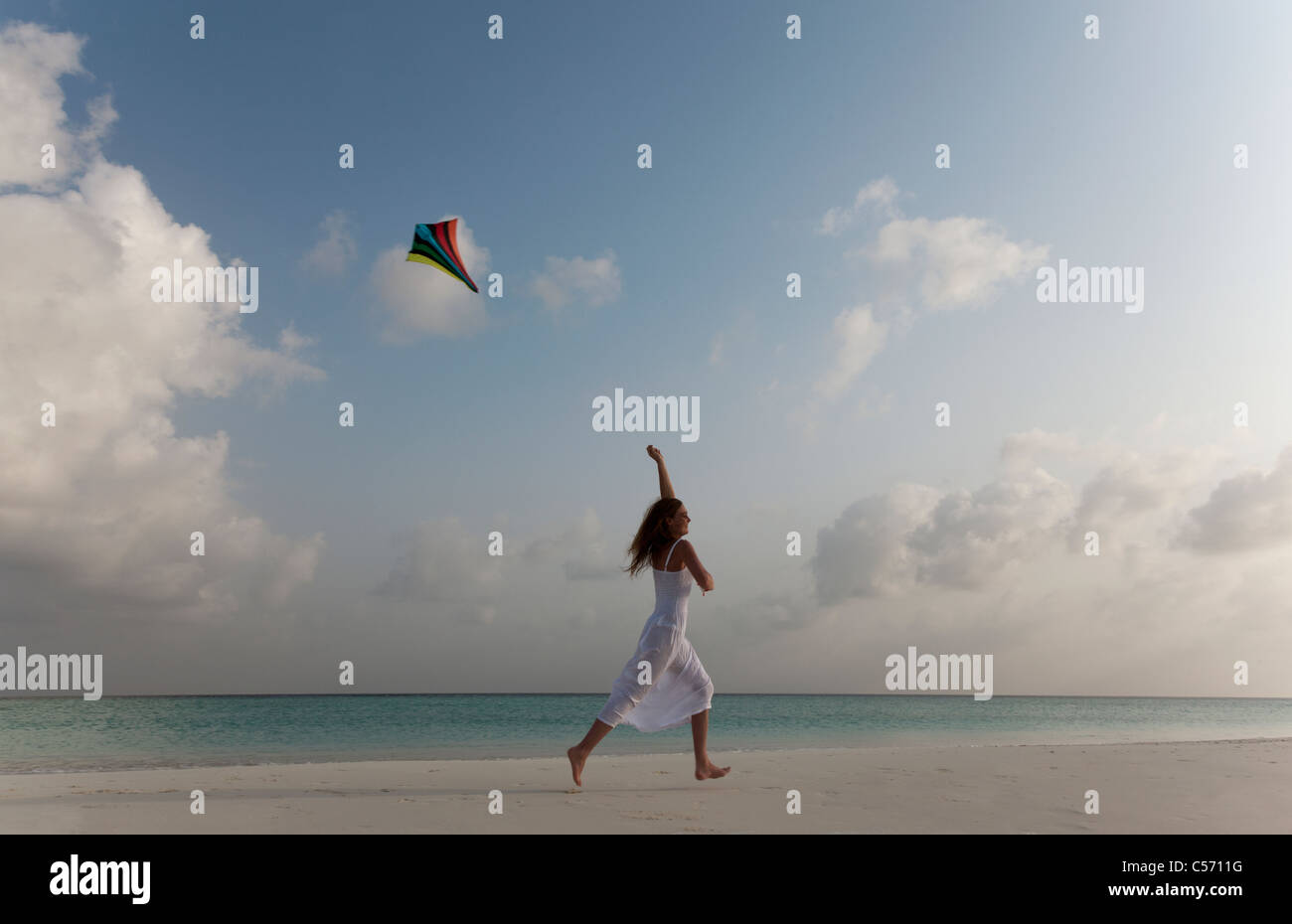 Person flying a kite on the beach hires stock photography and images