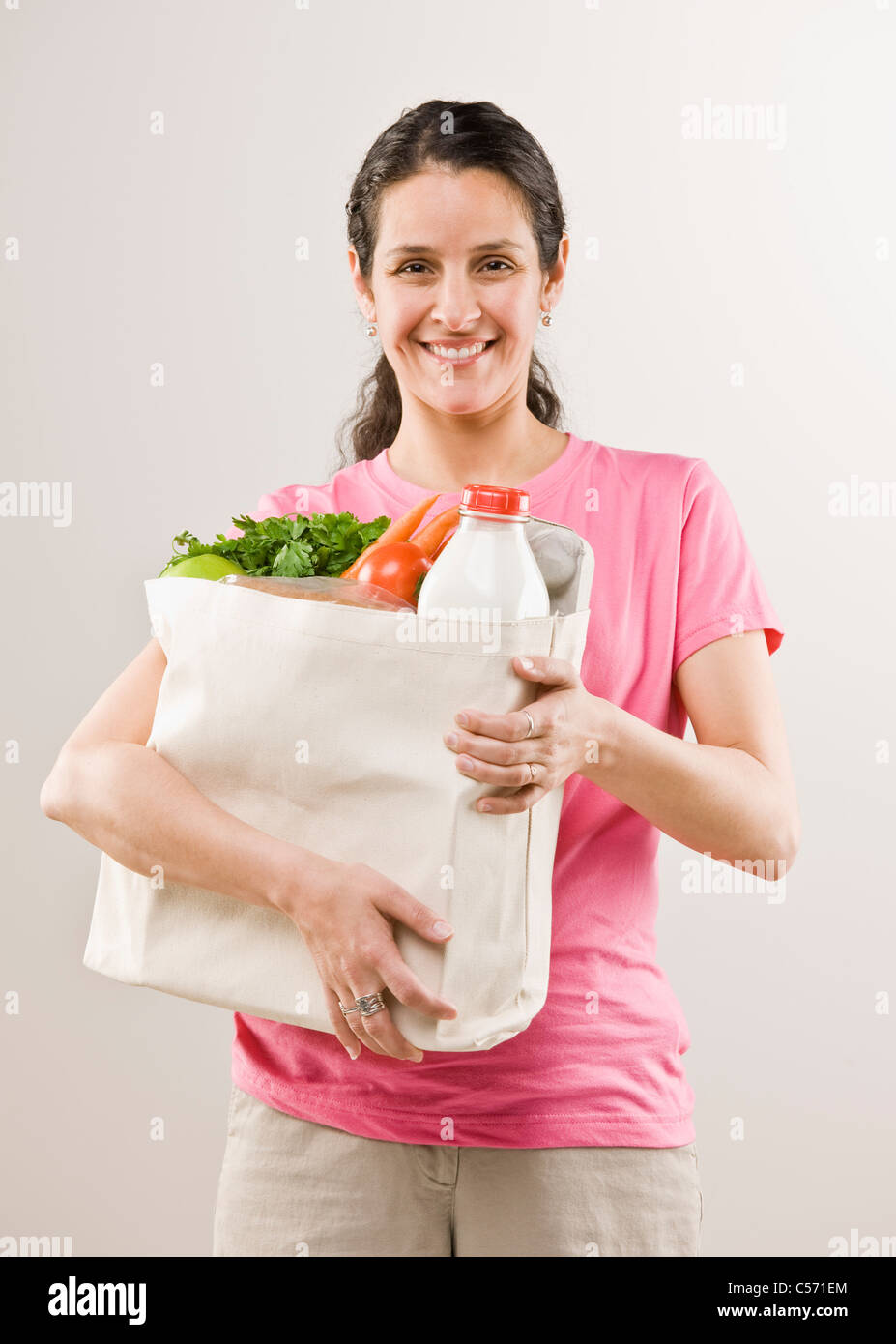 Woman carrying bag of groceries Stock Photo Alamy