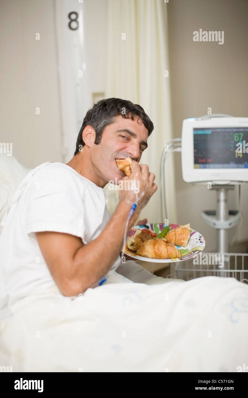 Hospital patient eating in bed Stock Photo Alamy