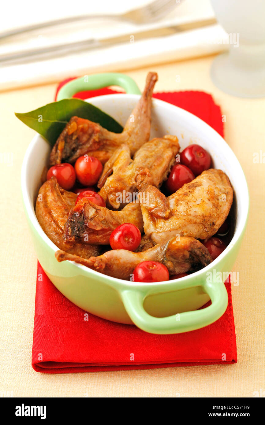 Quails with cherries. Recipe available Stock Photo