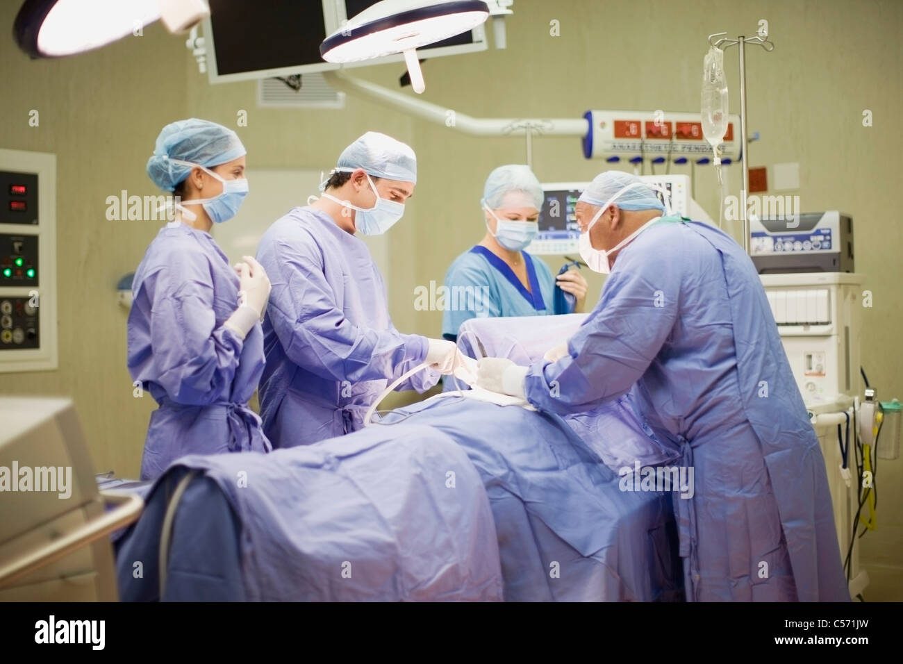 Doctor and nurses performing operation Stock Photo - Alamy