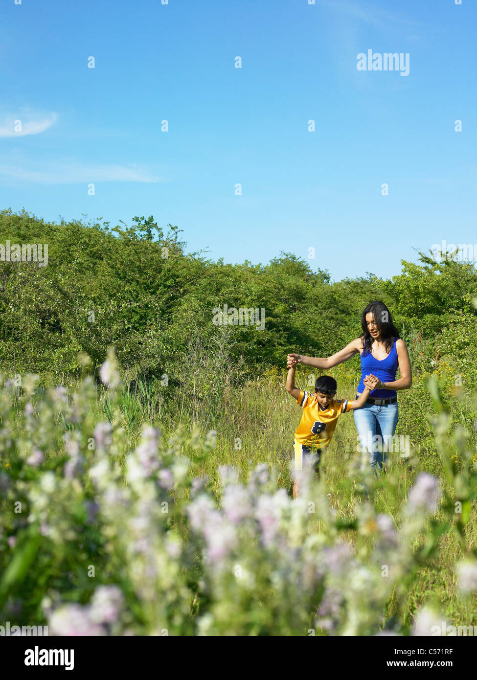 Mother and son in field of flowers Stock Photo - Alamy