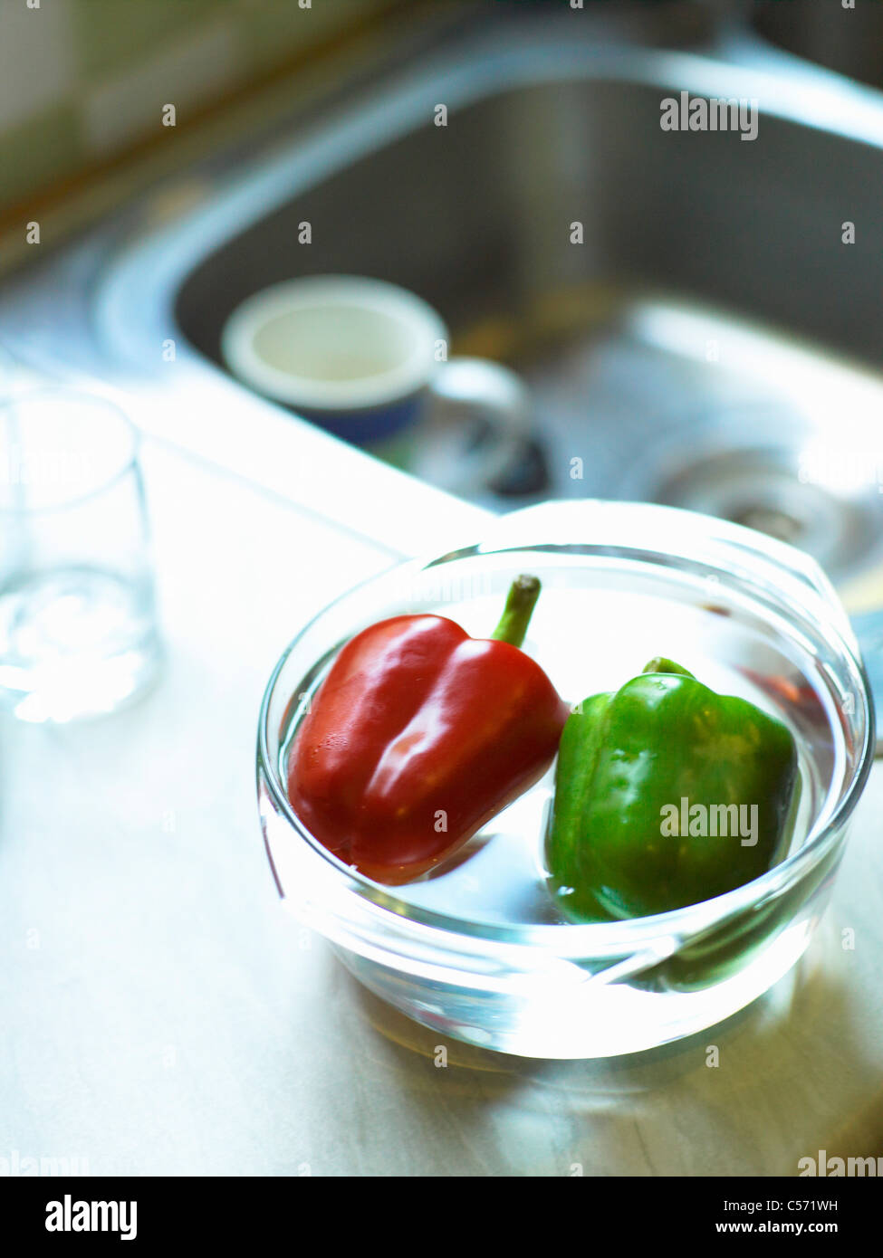 Peppers in bowl on sink Stock Photo