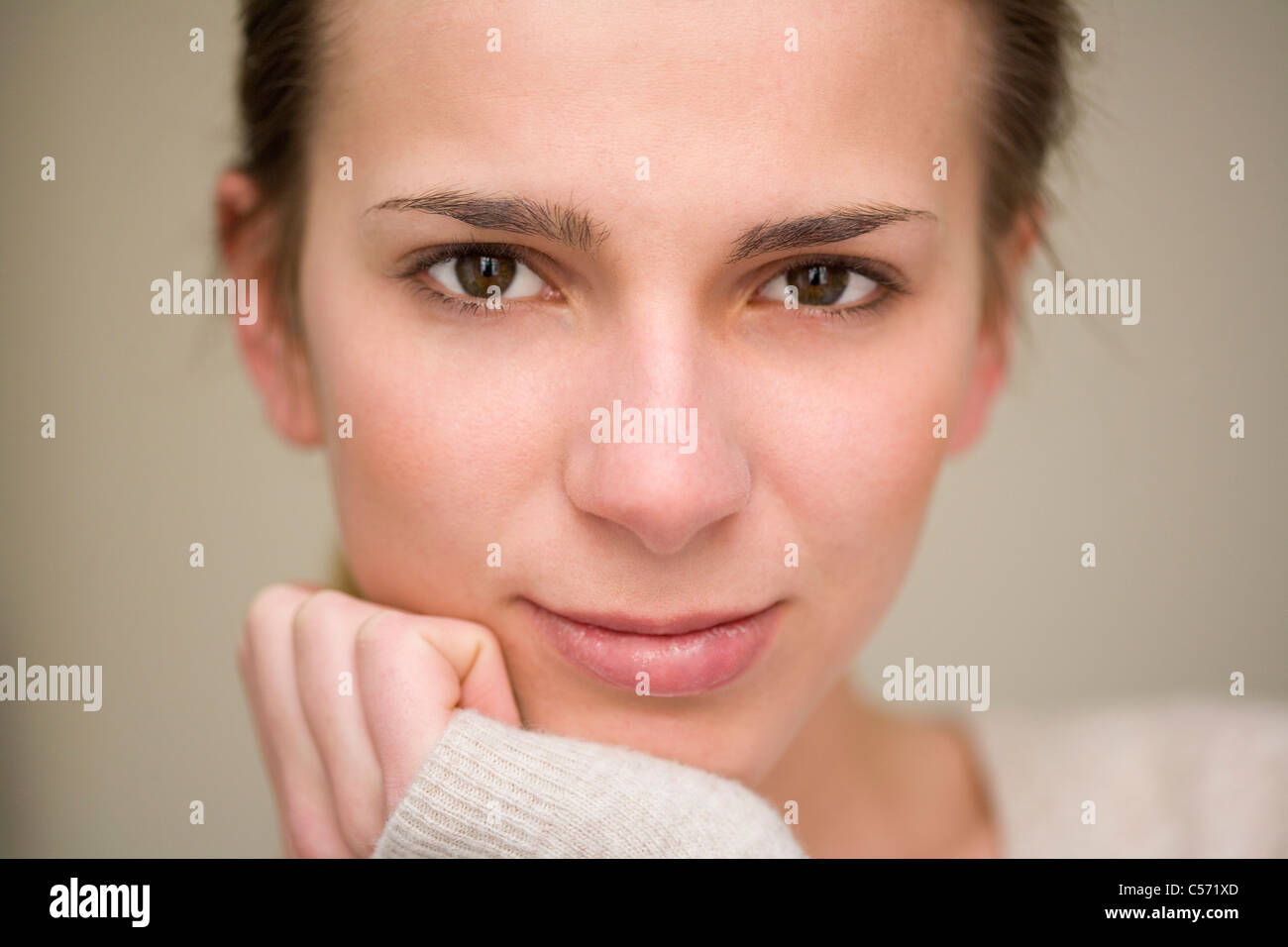 Woman resting chin in hand Stock Photo