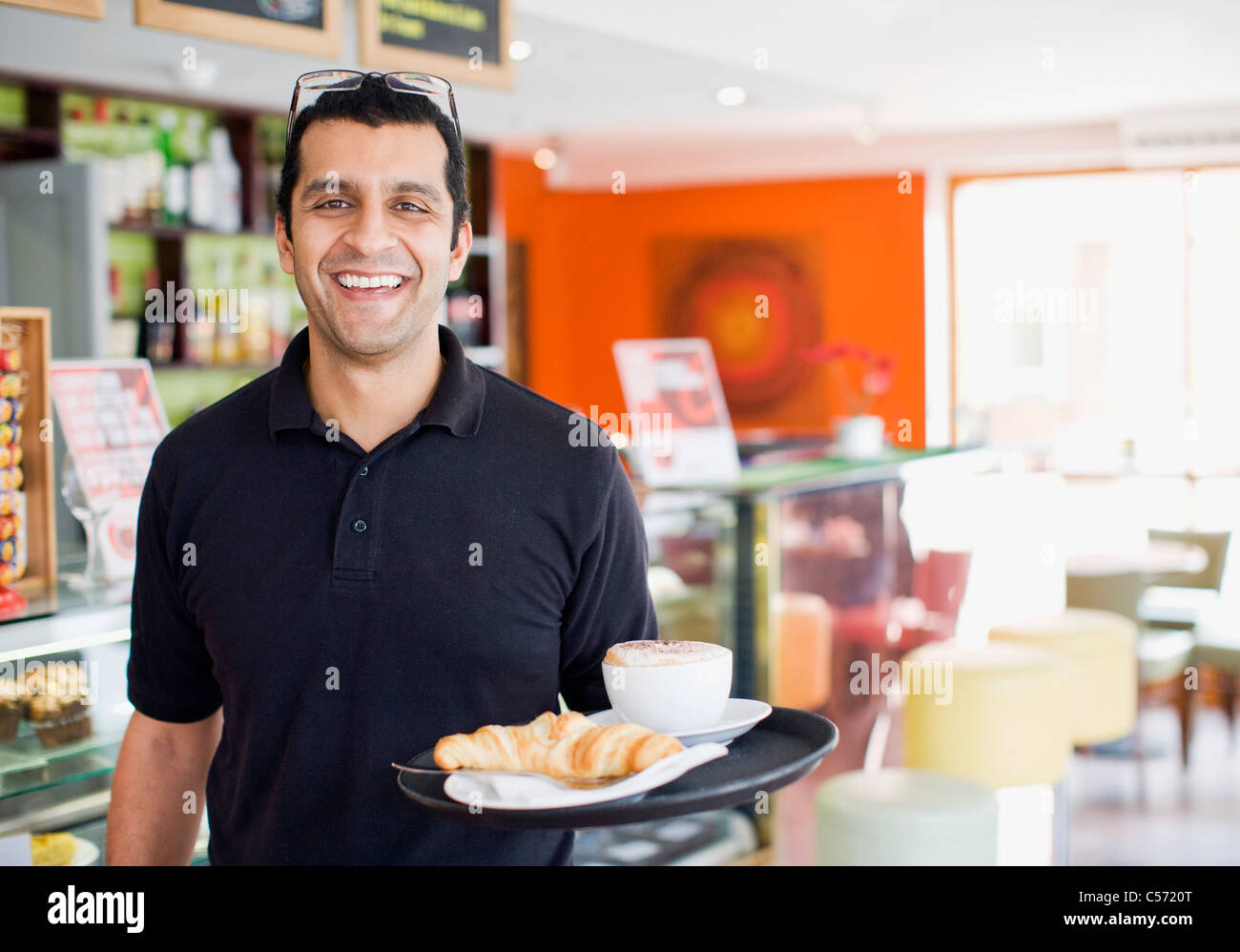 Man carrying tray of food in cafe Stock Photo Alamy