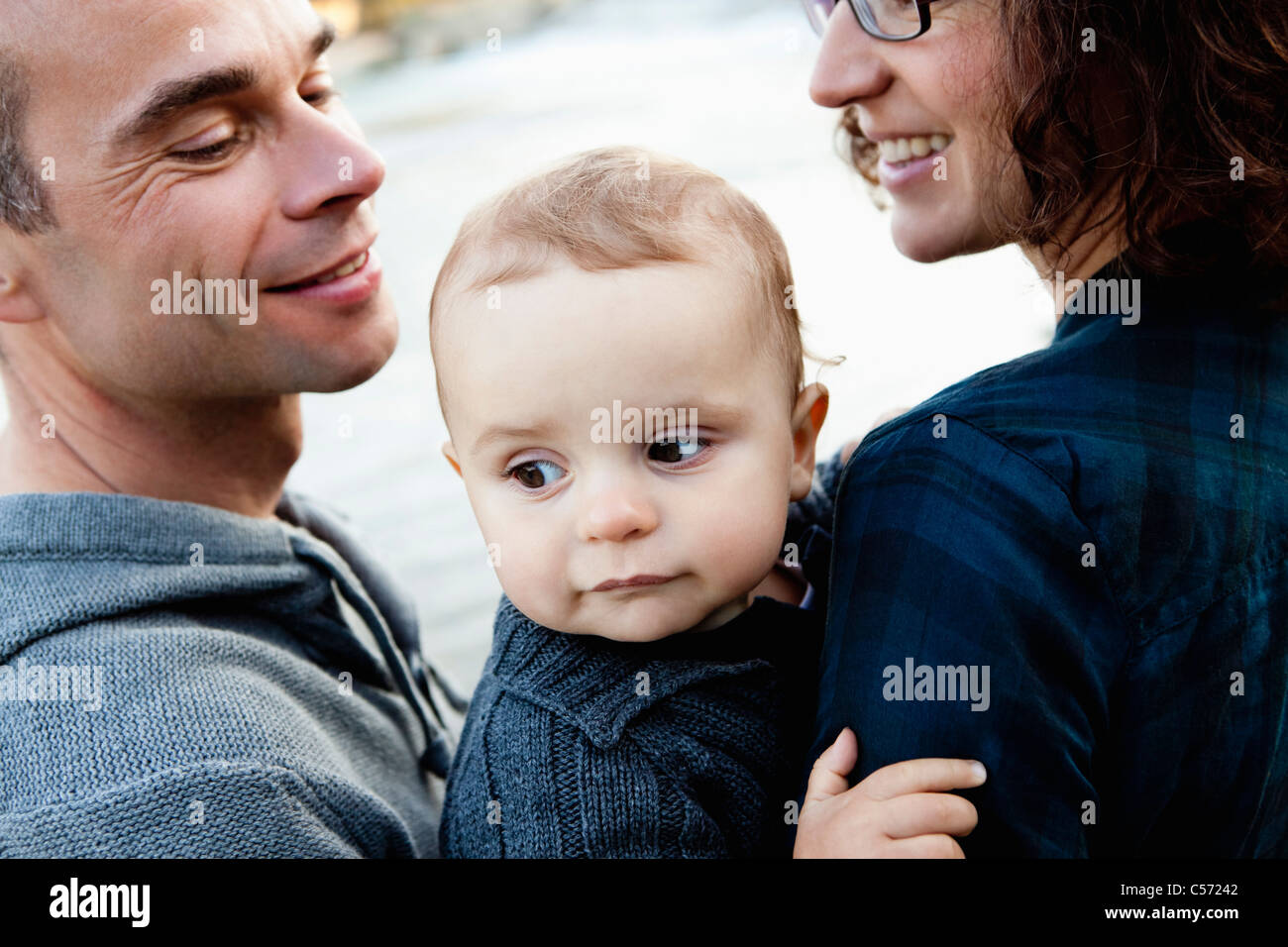 Smiling parents holding baby Stock Photo