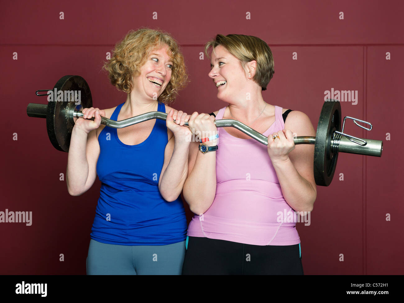 Older women lifting weights in gym Stock Photo Alamy