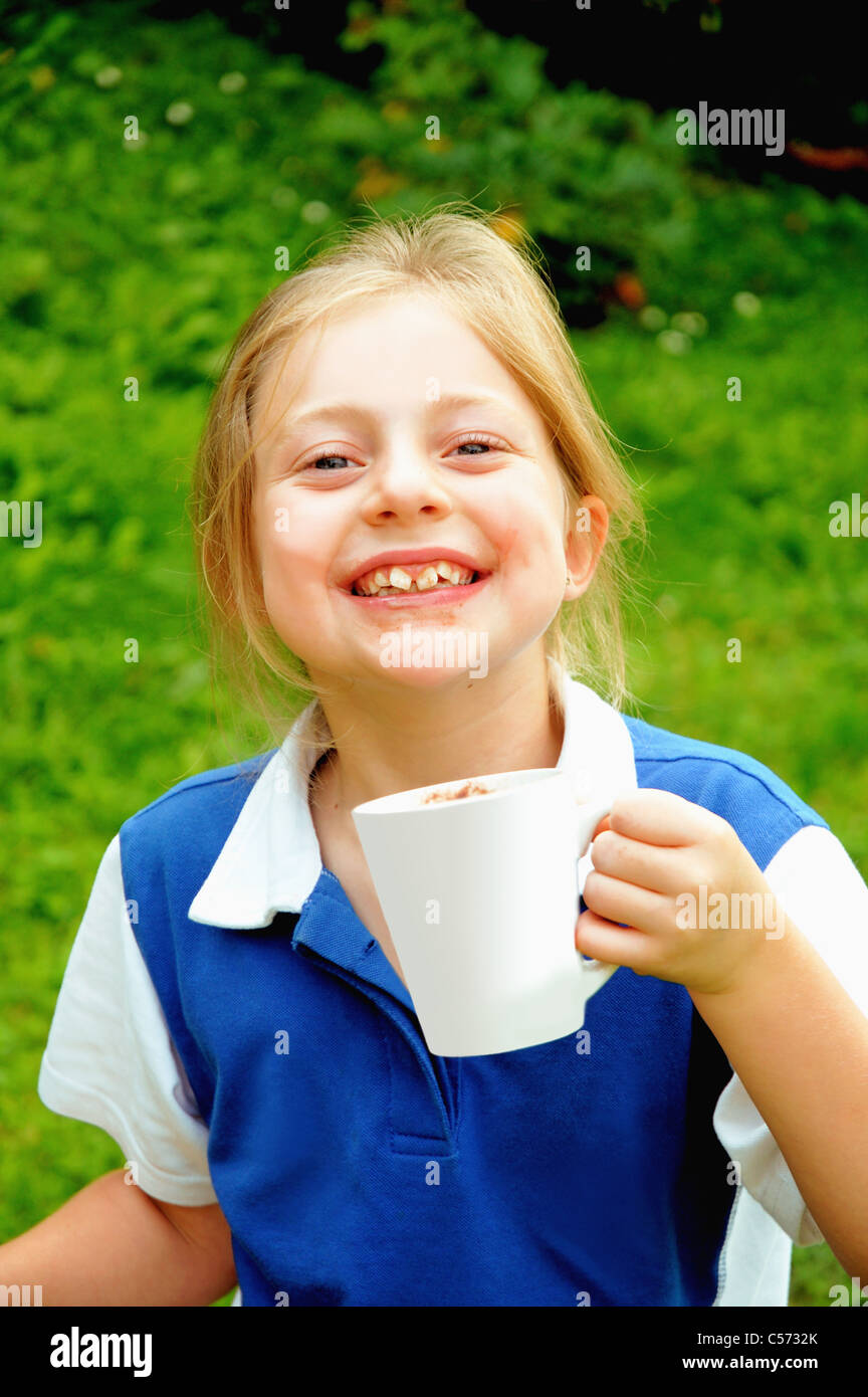 Girl drinking cup of coffee in backyard Stock Photo