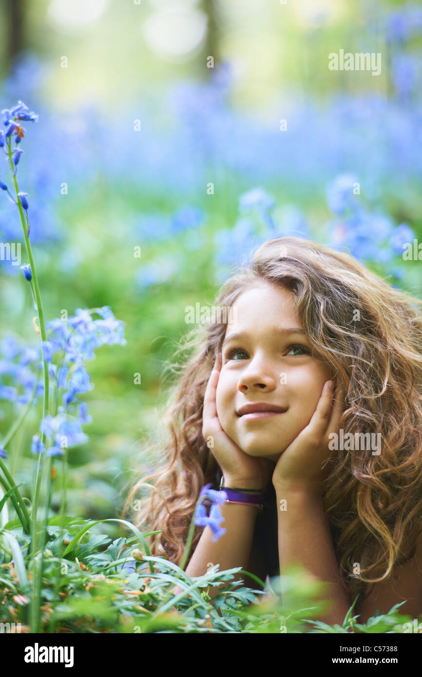 Girl laying in field of flowers Stock Photo