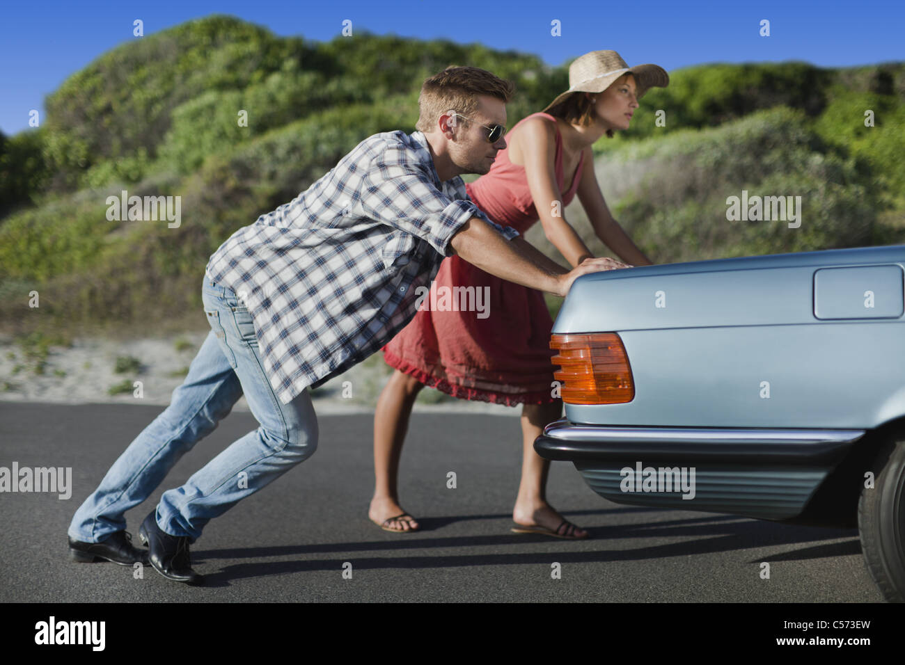 Couple Pushing Broken Down Car Stock Photo Alamy