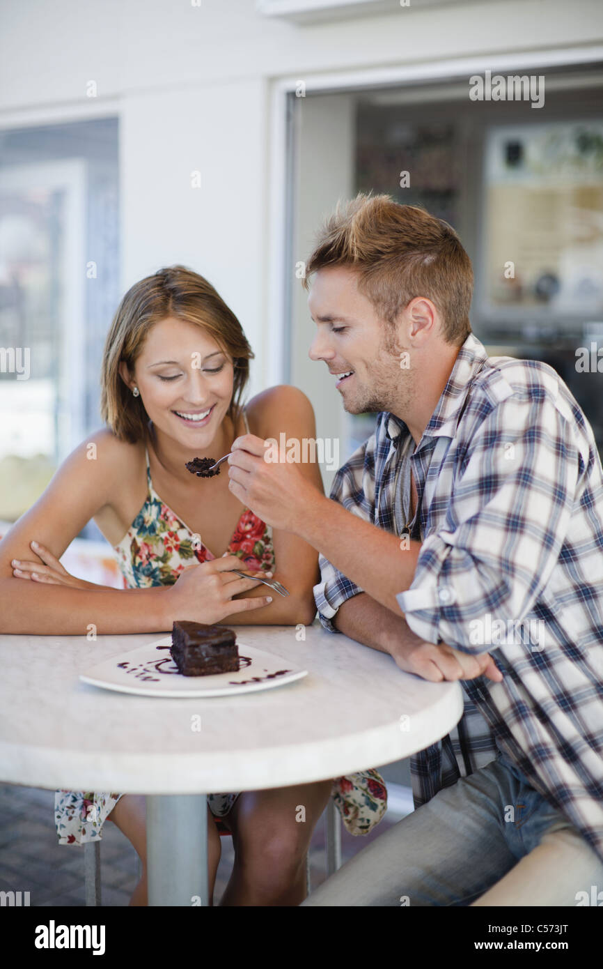 Couple sharing dessert at cafe Stock Photo