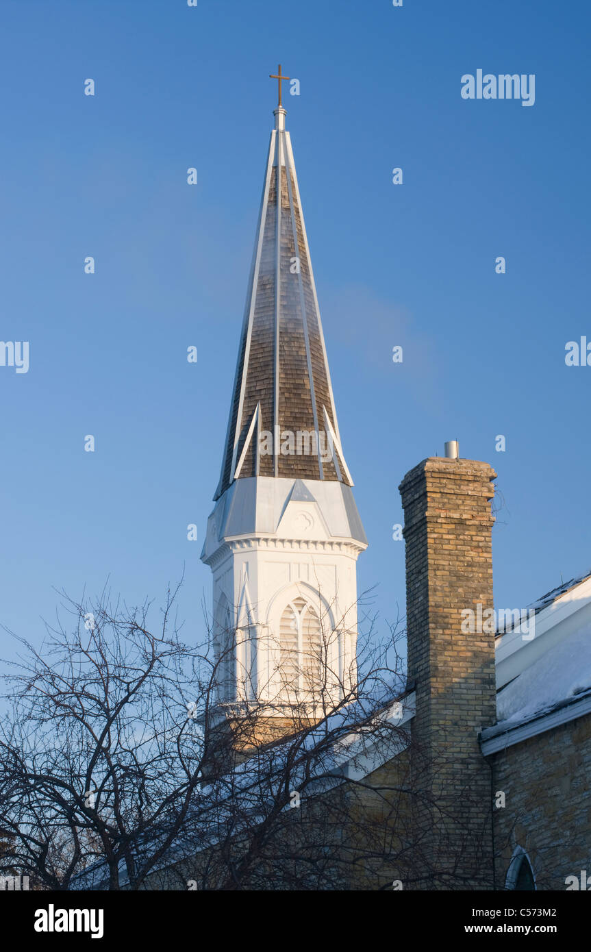 Church steeple and chimney under blue skies in mendota minnesota Stock Photo