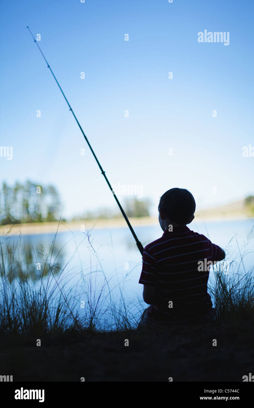 Boy fishing in lake Stock Photo