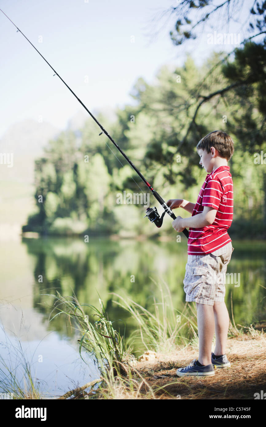 Boy fishing in lake Stock Photo