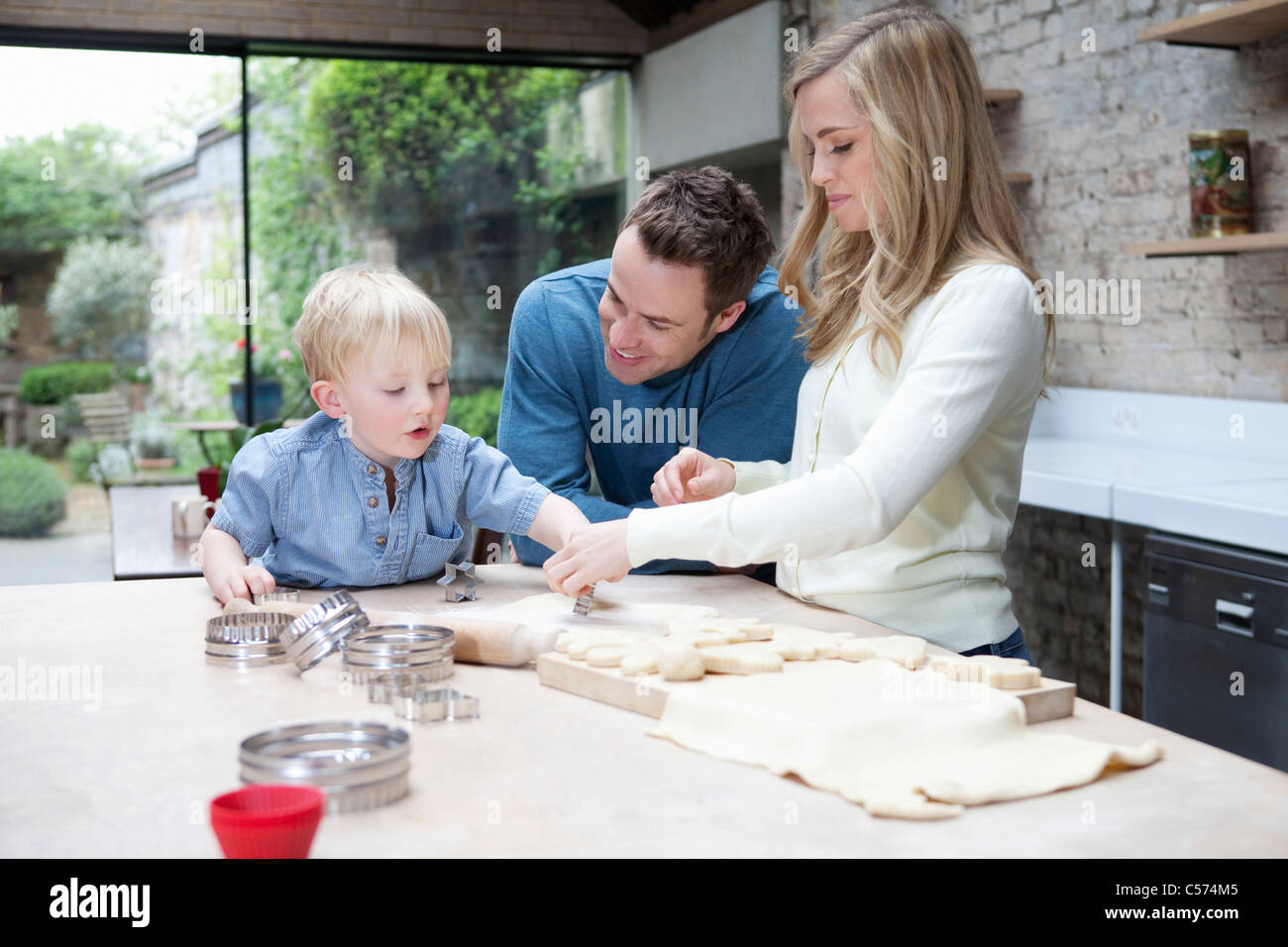 Family baking together in kitchen Stock Photo Alamy