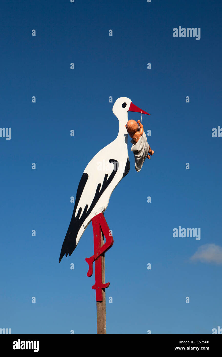 The Netherlands, Lattrop, Wooden stork with baby doll, to show the neighbourhood that a baby has born. Stock Photo