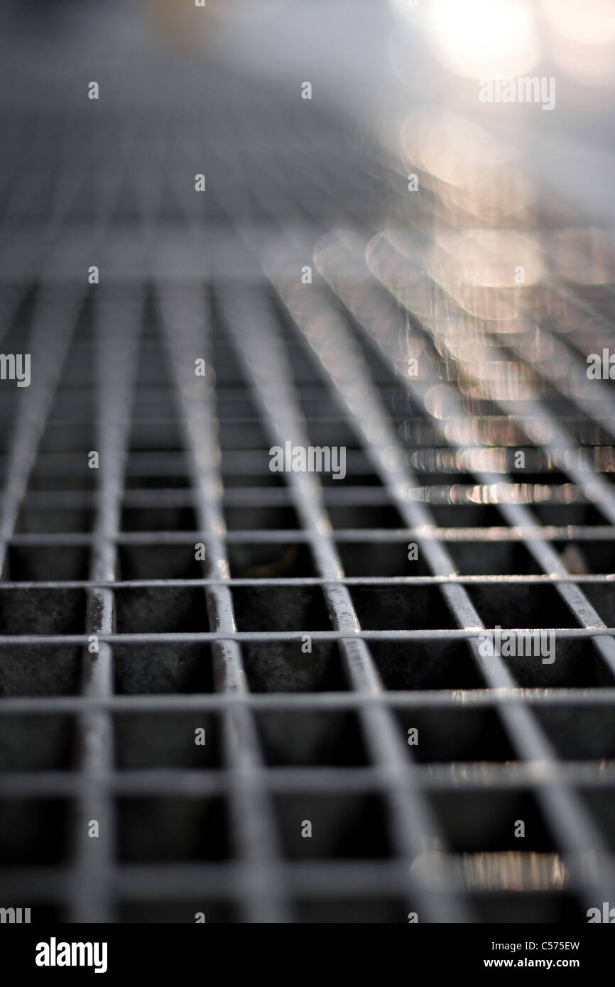 Closeup of a sidewalk subway grate with shallow depth of field. Stock Photo