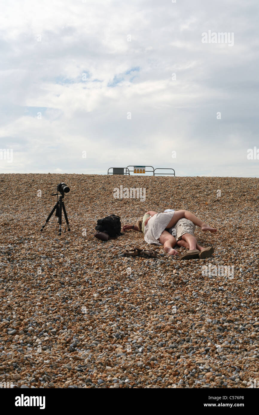 A couple kissing on Winchelsea Beach, Winchelsea, East Sussex,  England Stock Photo