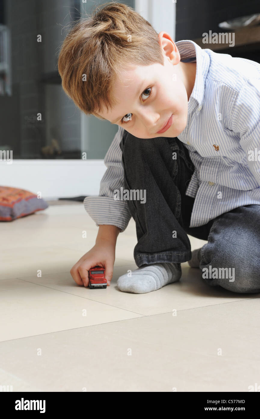 Boy playing with toy cars Stock Photo - Alamy
