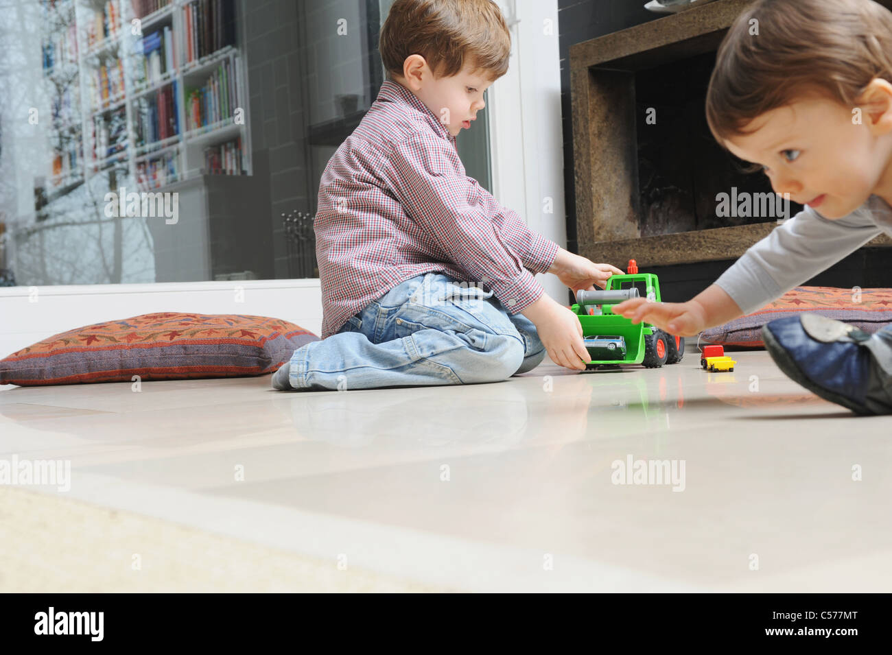 Boy playing with toy cars Stock Photo - Alamy