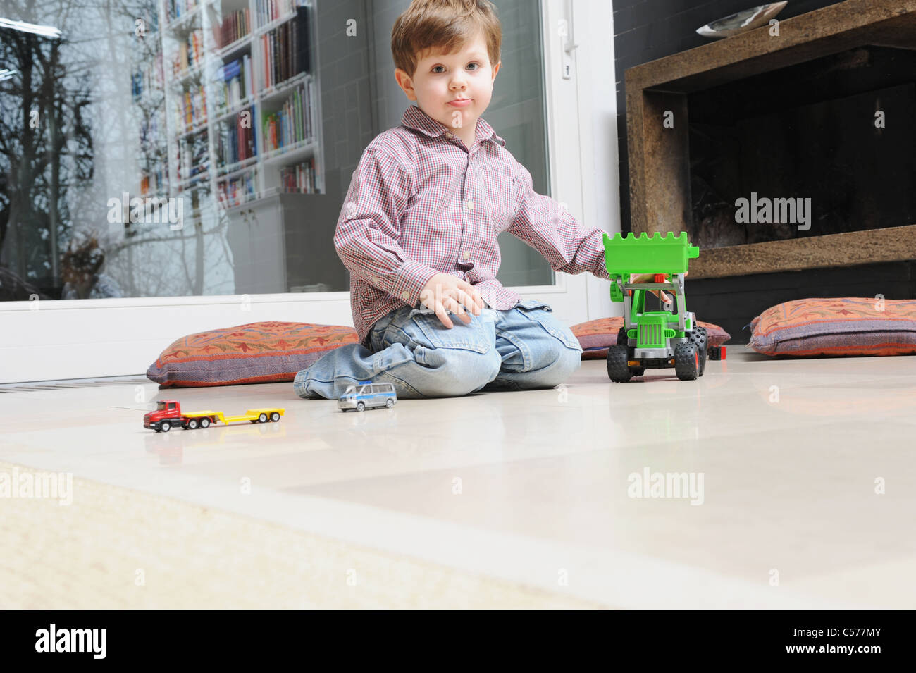 Boy playing with toy cars Stock Photo - Alamy