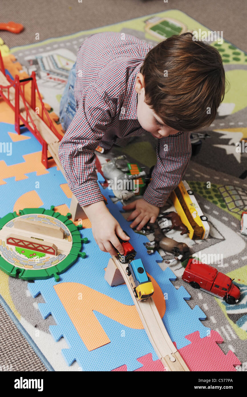 Boy playing with toy cars Stock Photo - Alamy