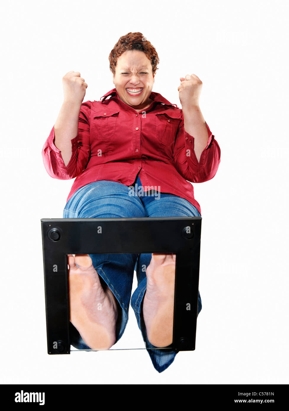 Large woman cheering on scales Stock Photo