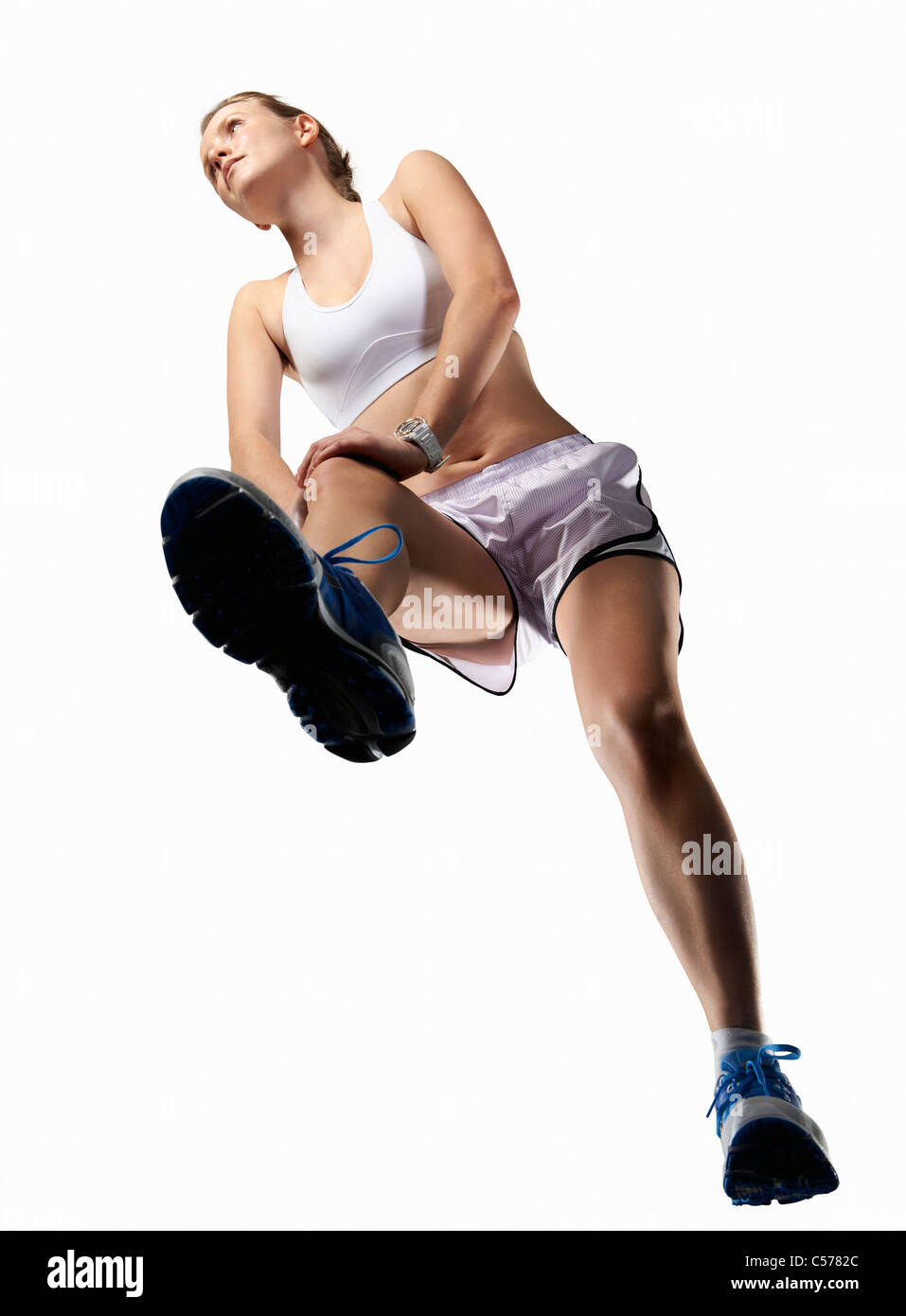 Low angle view of woman stretching Stock Photo