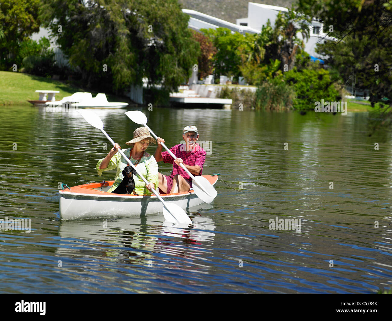 Older couple rowing canoe on lake Stock Photo - Alamy