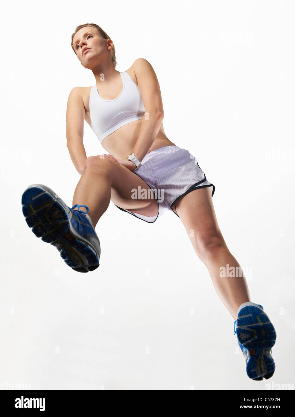 Low angle view of woman stretching Stock Photo
