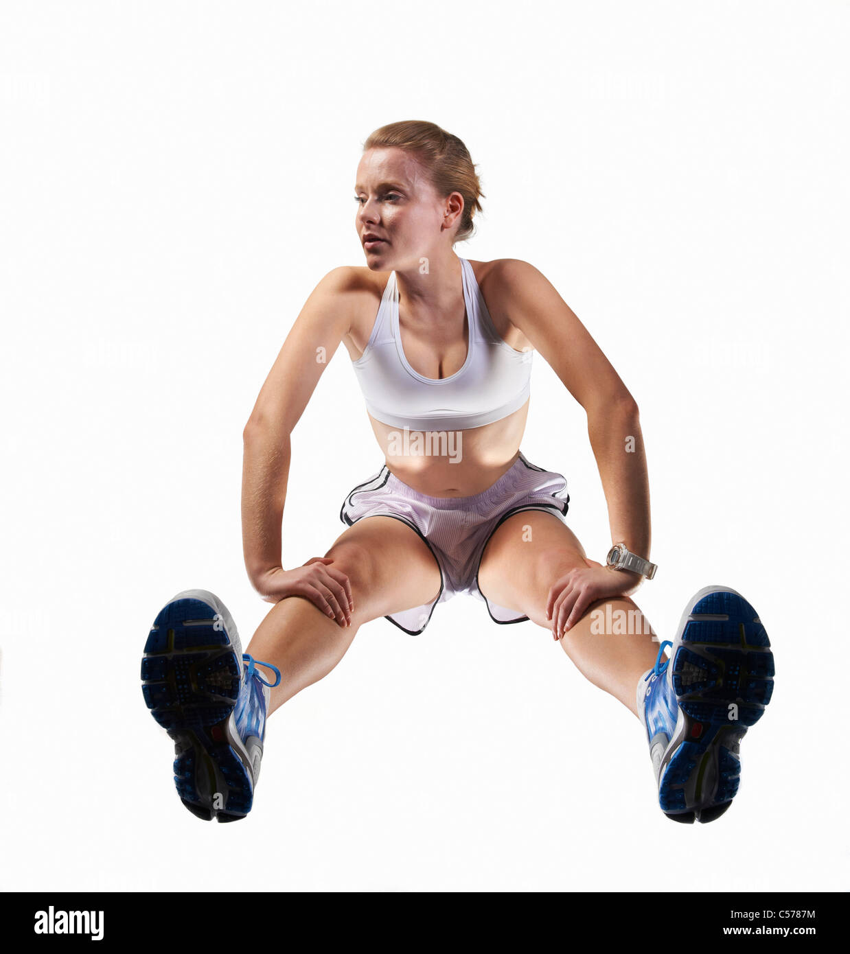 Low angle view of woman stretching Stock Photo